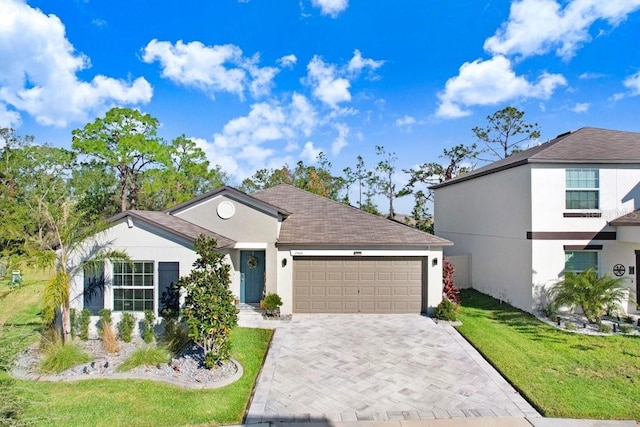 view of front of house featuring a front yard and a garage