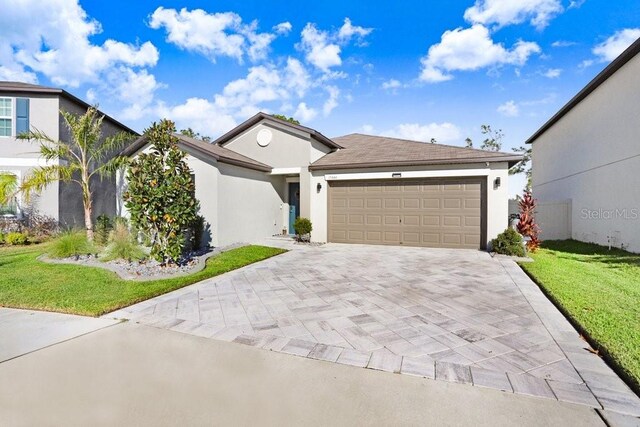 view of front of property featuring a front lawn and a garage