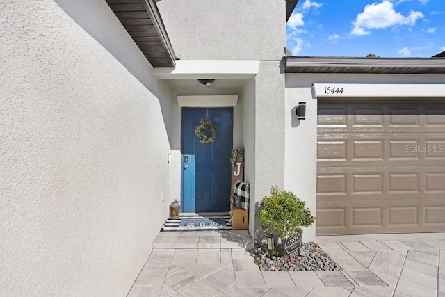 doorway to property with a garage