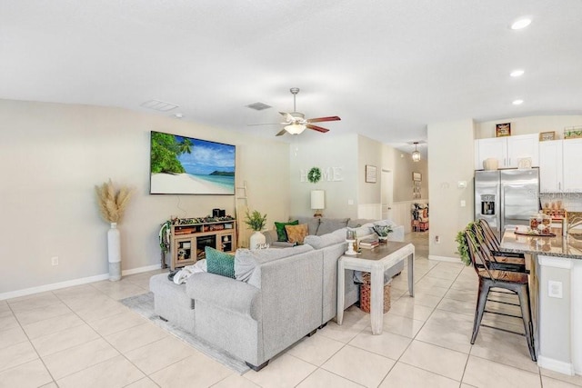 living room featuring light tile patterned floors and ceiling fan