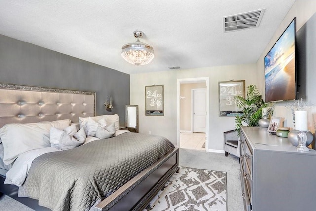 carpeted bedroom with a notable chandelier