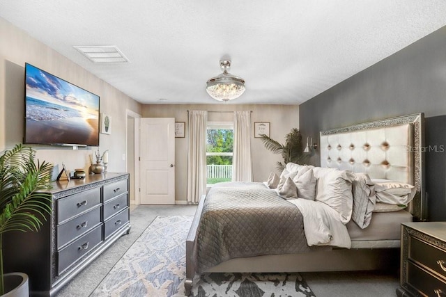 carpeted bedroom featuring a textured ceiling