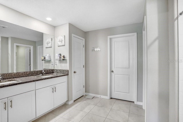 bathroom featuring tile patterned flooring and vanity