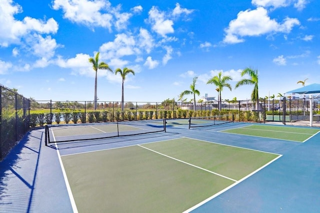 view of tennis court featuring basketball hoop