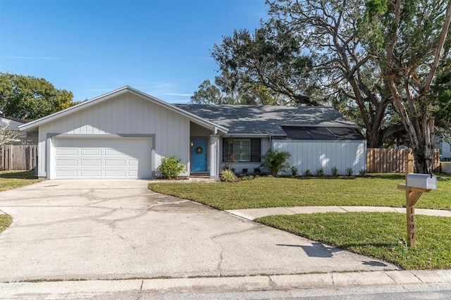 ranch-style home with a garage and a front yard