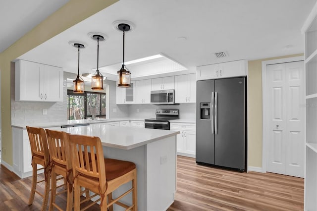 kitchen featuring stainless steel appliances and white cabinetry