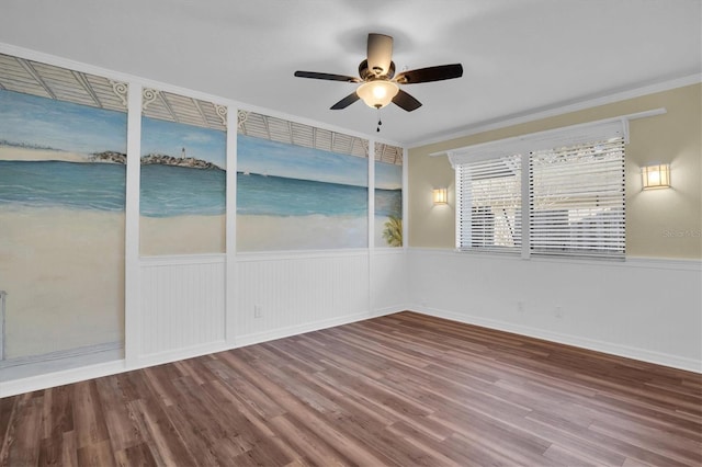 empty room featuring hardwood / wood-style flooring, ceiling fan, and ornamental molding