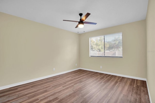 spare room with hardwood / wood-style flooring and ceiling fan