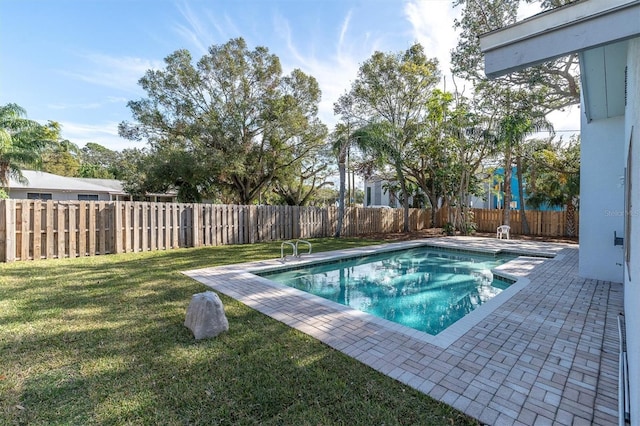 view of pool featuring a yard and a patio