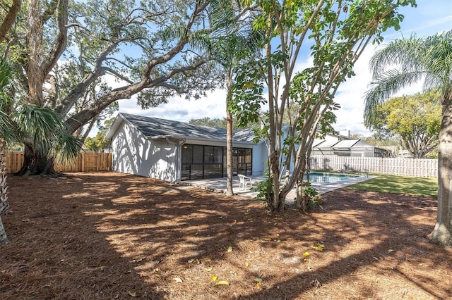 view of yard featuring a fenced in pool and a patio