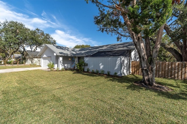 view of front of property featuring a garage and a front lawn