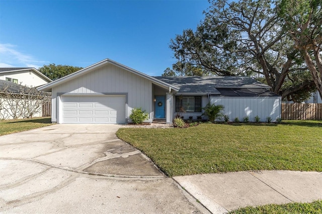 single story home with a garage and a front lawn