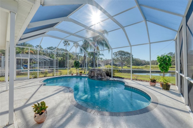 view of pool with a patio, a water view, and glass enclosure