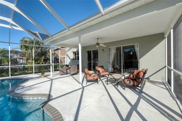 exterior space with beam ceiling, ceiling fan, and a swimming pool