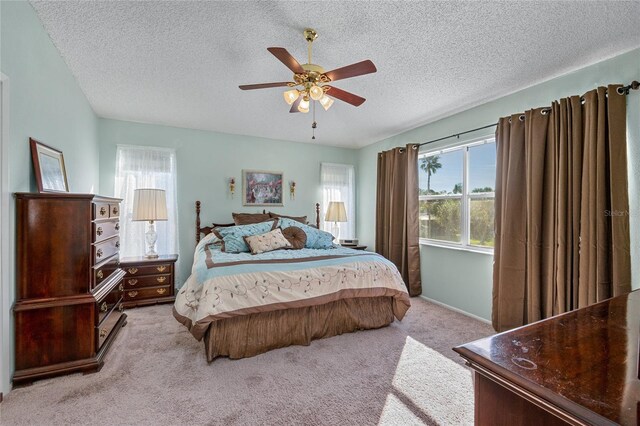 carpeted bedroom with a textured ceiling and ceiling fan