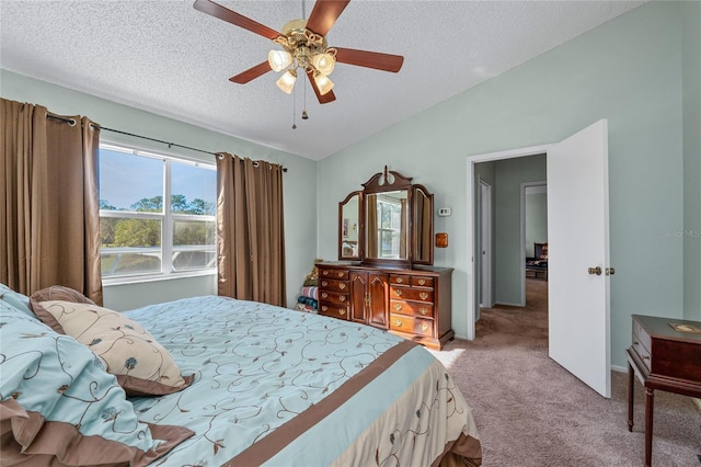 carpeted bedroom featuring ceiling fan, lofted ceiling, and a textured ceiling