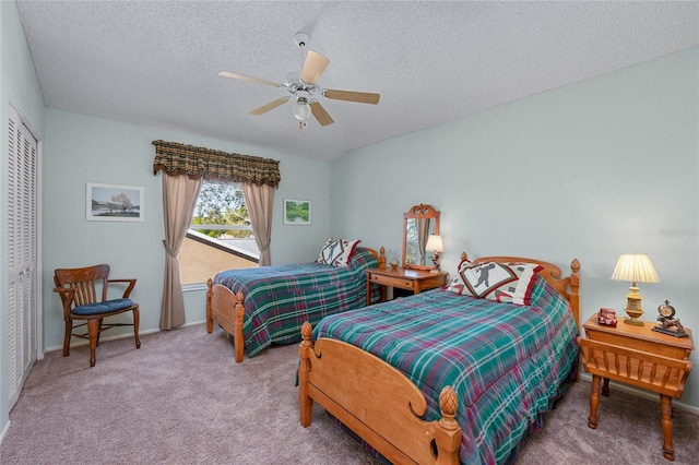 bedroom featuring carpet, a textured ceiling, a closet, and ceiling fan