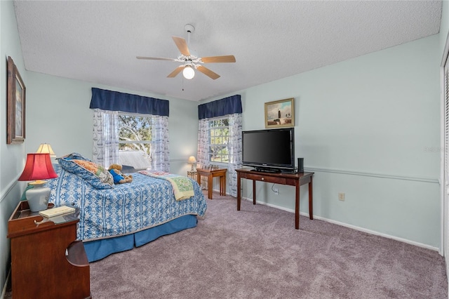 bedroom featuring carpet flooring, ceiling fan, and a textured ceiling