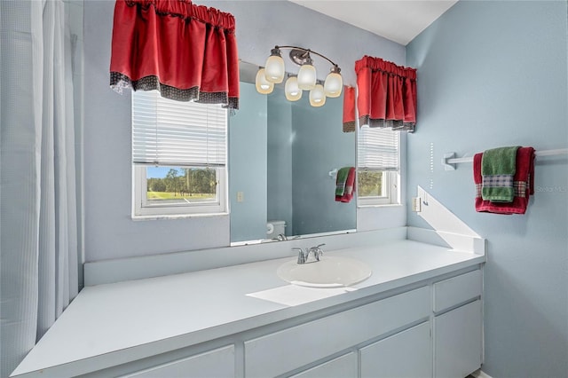 bathroom featuring vanity, toilet, and a wealth of natural light