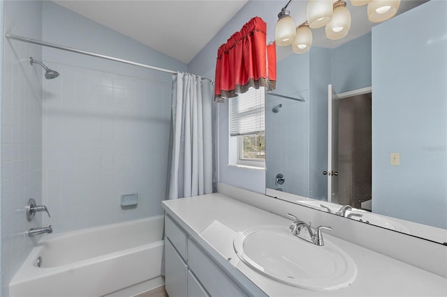 bathroom with shower / tub combo, vanity, and lofted ceiling