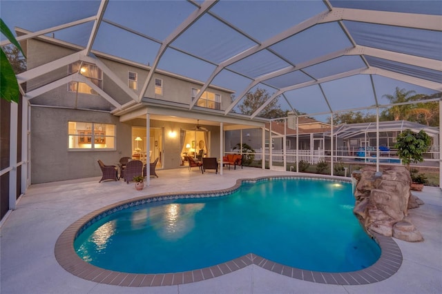 view of pool featuring ceiling fan, a lanai, and a patio