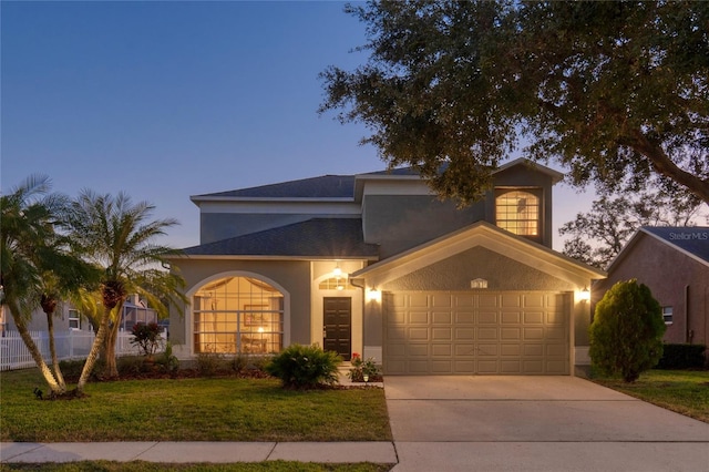 view of front of house featuring a yard and a garage