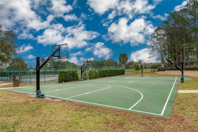 view of sport court with a lawn and tennis court