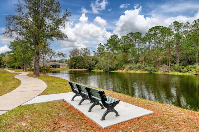 surrounding community featuring a lawn and a water view