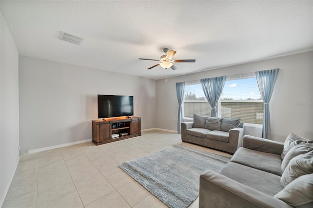 living room featuring light tile patterned floors and ceiling fan