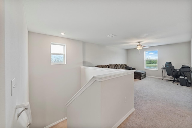 office space with light carpet and ceiling fan