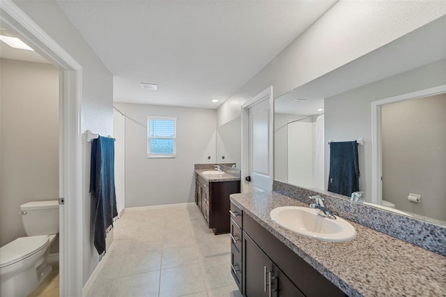 bathroom featuring tile patterned floors, vanity, and toilet