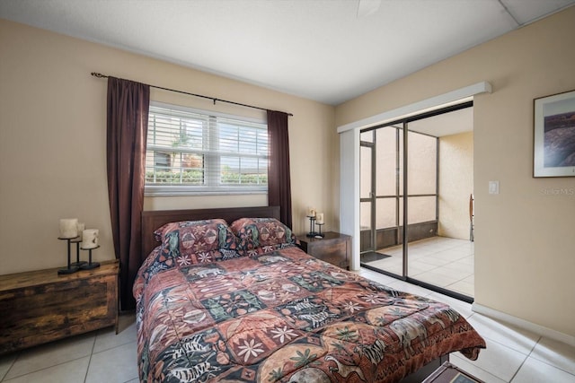 bedroom with light tile patterned floors and a closet