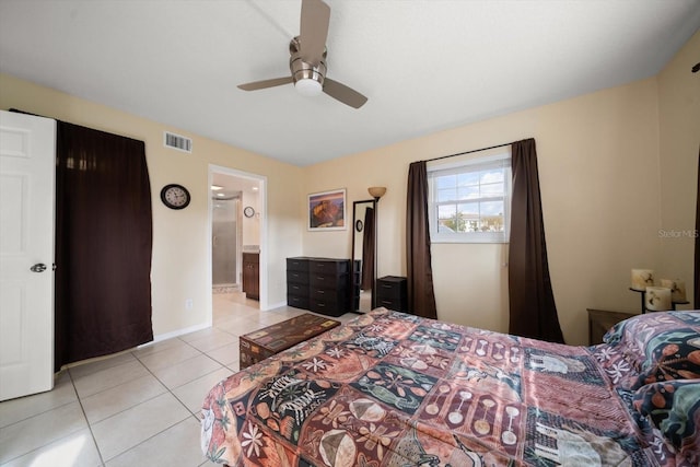 bedroom featuring ceiling fan, light tile patterned floors, and ensuite bathroom