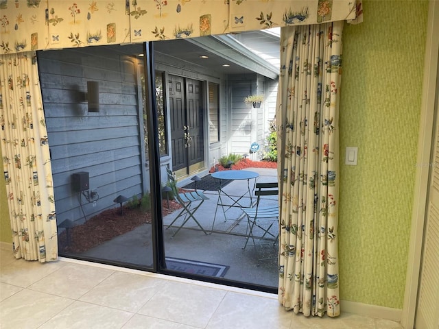 doorway to outside featuring tile patterned flooring