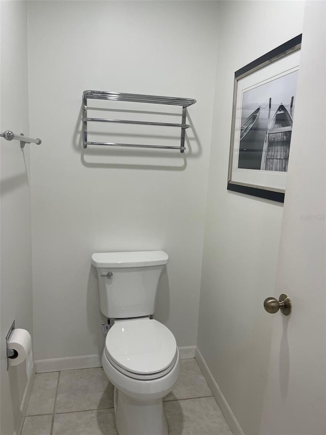 bathroom with tile patterned flooring and toilet