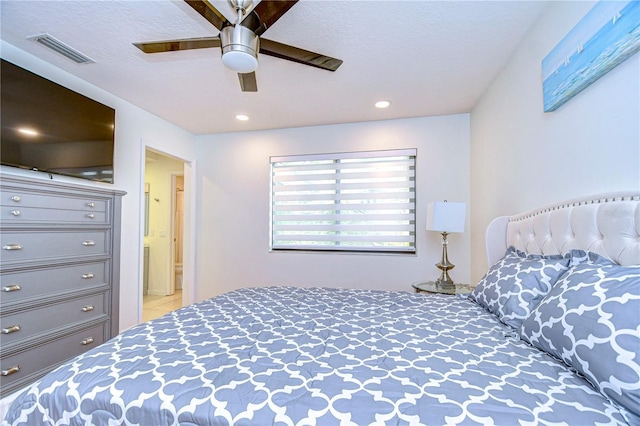 bedroom featuring a textured ceiling and ceiling fan