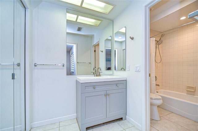 full bathroom featuring tile patterned floors, tiled shower / bath combo, toilet, and vanity