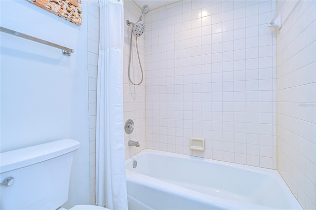 bathroom featuring shower / tub combo with curtain and toilet