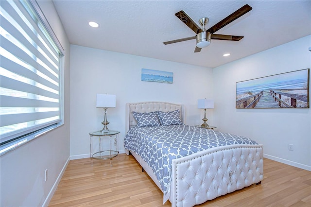 bedroom featuring ceiling fan and light hardwood / wood-style flooring