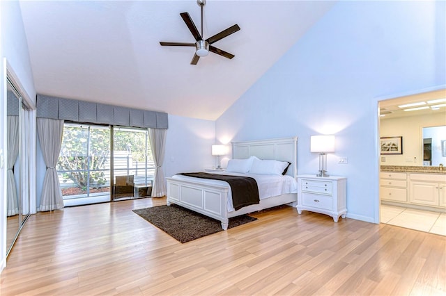 bedroom featuring ensuite bath, ceiling fan, light hardwood / wood-style flooring, and high vaulted ceiling