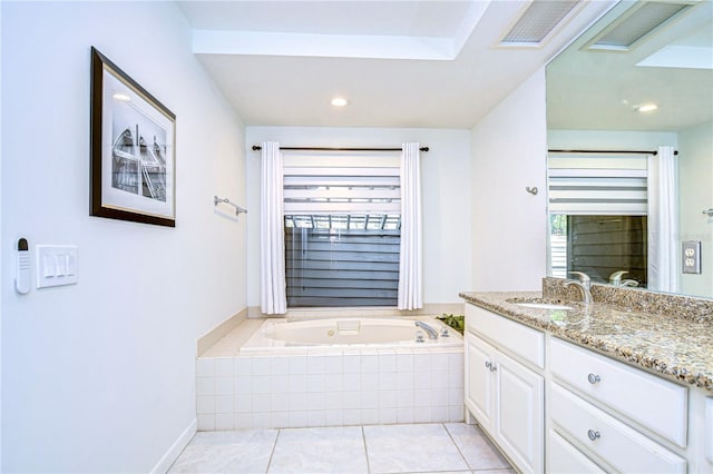 bathroom featuring tile patterned flooring, vanity, and a relaxing tiled tub