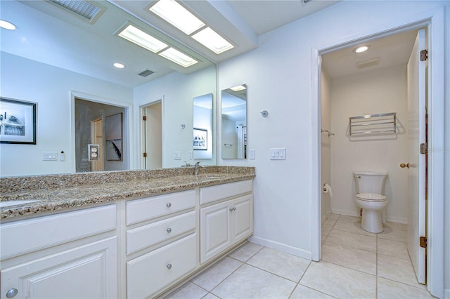 bathroom with tile patterned floors, vanity, and toilet