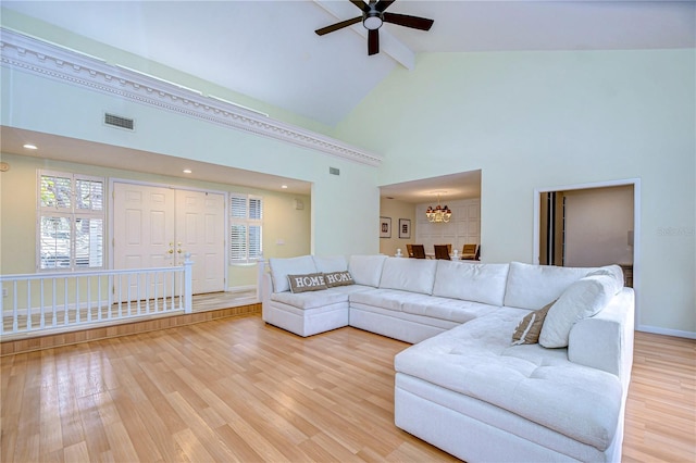 living room with hardwood / wood-style floors, ceiling fan, beam ceiling, and high vaulted ceiling