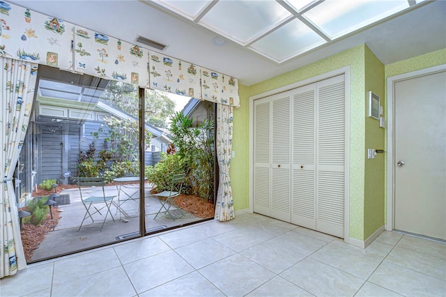 doorway with light tile patterned flooring