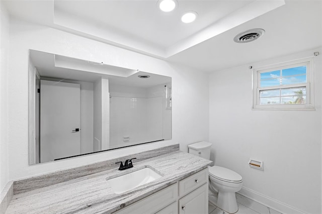 bathroom with walk in shower, tile patterned flooring, toilet, a tray ceiling, and vanity