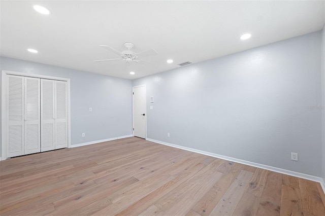 unfurnished bedroom featuring ceiling fan, a closet, and light hardwood / wood-style floors