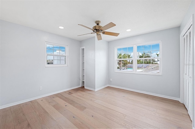 unfurnished bedroom featuring light wood-type flooring, a closet, and ceiling fan