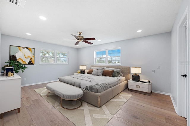 bedroom with ceiling fan and light hardwood / wood-style flooring