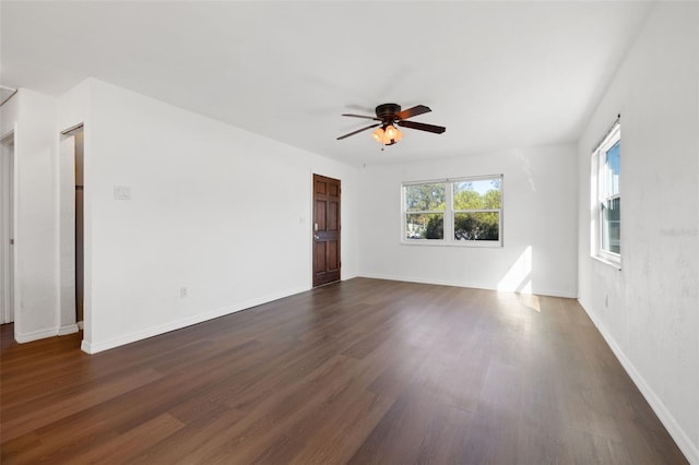 spare room with ceiling fan and dark wood-type flooring