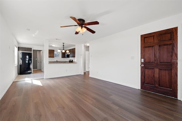 unfurnished living room with ceiling fan and hardwood / wood-style floors